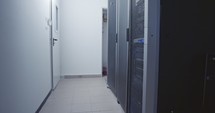 Large computer server room in a data center with blinking lights
