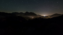 Starry night to day sunrise in mountains forest Time lapse