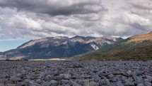 Grey Clouds moving over alpine mountains valley in sunny summer in New Zealand wild nature time-lapse
