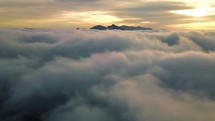 Peaceful aerial view of clouds at sunrise.
