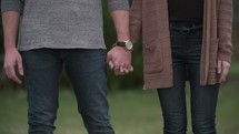 couple standing together holding hands 