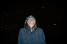 a child catching snowflakes with her tongue 