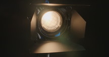 Film light fixture on dark studio background.