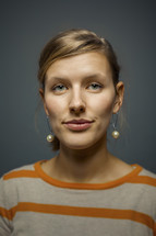 headshot of a woman with pearl earrings 