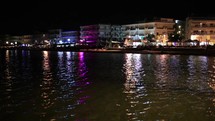 Illuminated waterfront buildings at night