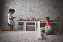 girl playing with legos in a playroom 