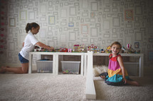 girls playing with legos in a playroom 