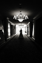Bride walking down hallway of mirrors silhouette 