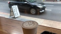 passing cars and coffee cup in a window 