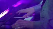 man playing a digital piano 