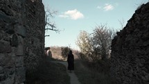 Girl walking near an ancient fortress