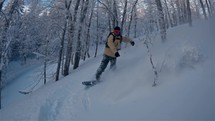 Slow motion of Snowboarder riding freeride in frozen winter forest Snowboarding
