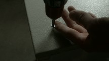 using a power screwdriver to screw into metal 