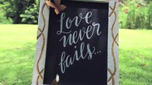 love never fails sign 