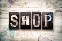 word shop on a white wash wood background 