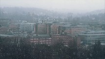 falling snow over a mountain town 