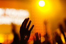 Hands raised in worship orange flare