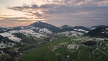 Evening colors over snowy rural landscape in early spring countryside. Aerial Time lapse hyperlapse
