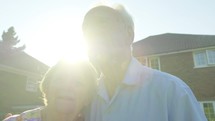 Portrait of a senior caucasian couple backlit by the sun in their garden