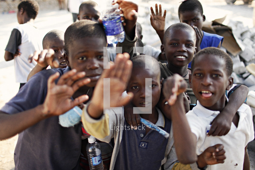 Group of children waving.