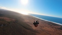 Fly Paragliding in Morocco ocean coast in sunny summer adventure, Extreme sport freedom flight
