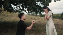 young man proposing a young woman