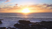 Calm evening on west coast with sunset over ocean in New Zealand wild nature Slow motion 
