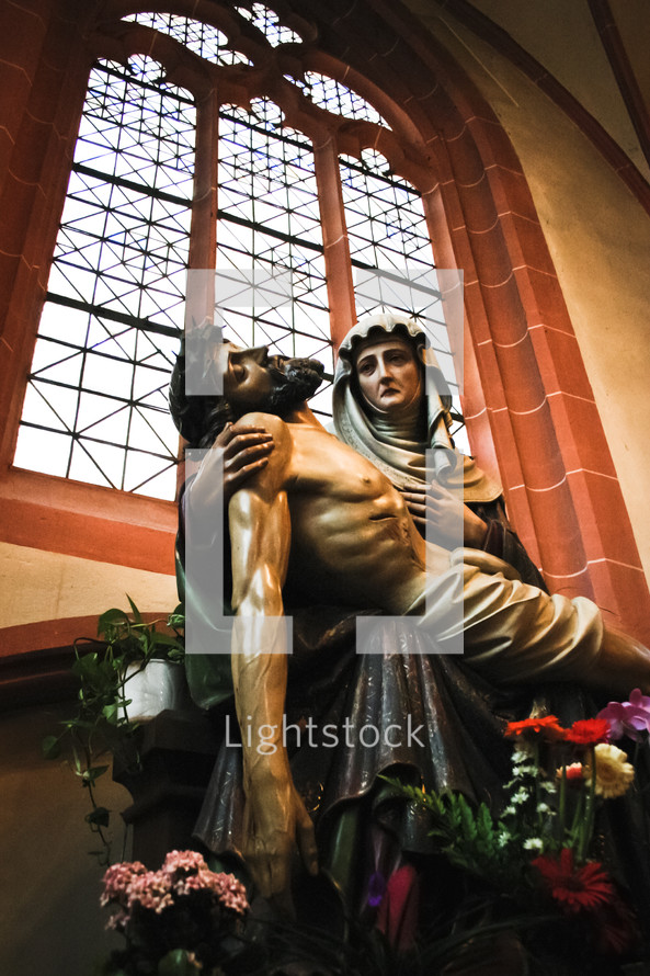 a statue of Mary holding Jesus body after his death 