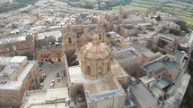 4k aerial drone footage, circling around  St Paul's Cathedral in the stone fortified walled city of Mdina of the Northern Region of Malta.