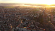Epic mystic foggy aerial sunrise over Arles southern french town romanesque buildings