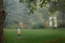 a girl running in her backyard 