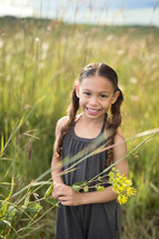 a girl in a field of tall grasses 