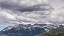 Dramatic clouds moving fast over alpine mountains in New Zealand wilderness landscape time-lapse
