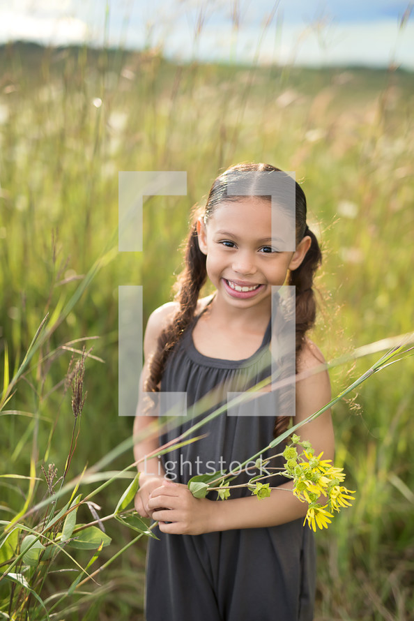 a girl in a field of tall grasses 