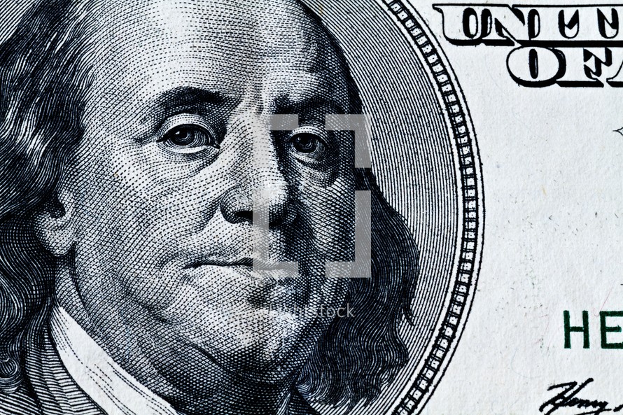 A closeup of Benjamin Franklin on a one hundred dollar bill