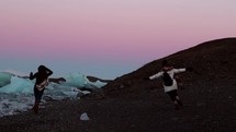 women running on a shore in Iceland 
