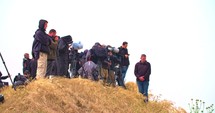 Photographers and cameramen on a hill near the border of Gaza.