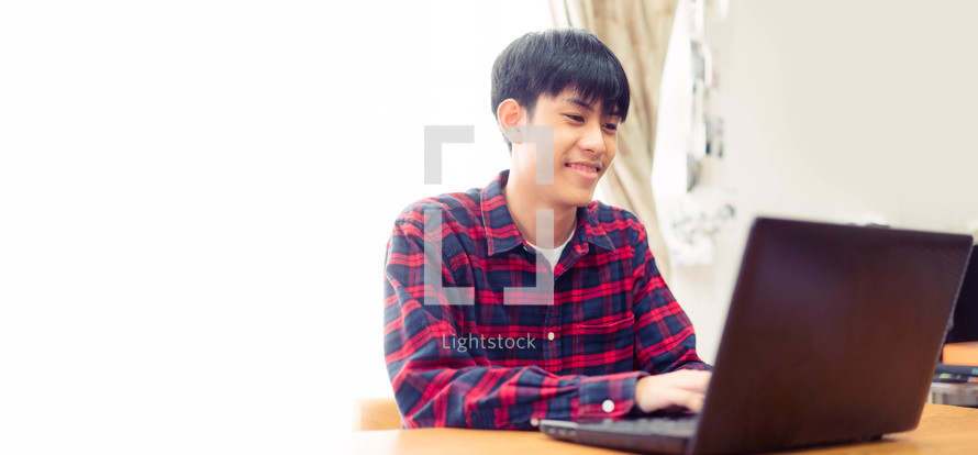 young man working on a laptop computer 