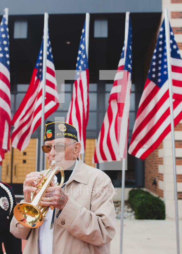 A Veteran playing a trumpet to honor fallen soldiers