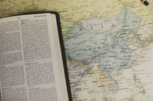 Bible on a map of Asia