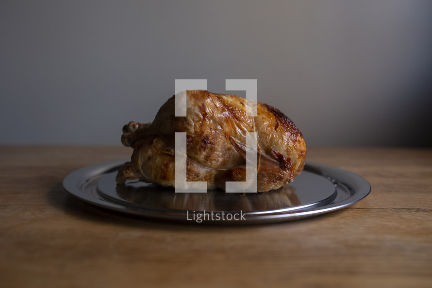 roast chicken on a silver platter 