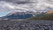 Grey Clouds moving over alpine mountains valley in sunny summer in New Zealand wild nature Time lapse