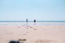 distant children playing on a beach 