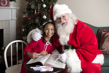 Santa and a little girl coloring together 