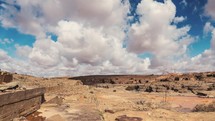Timelapse of clouds moving over desert country landscape in Morocco.