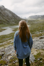 a woman standing on a mountainside in Norway 