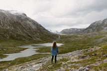 a woman standing on a mountainside in Norway 