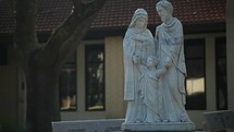 holy family statue in a courtyard 