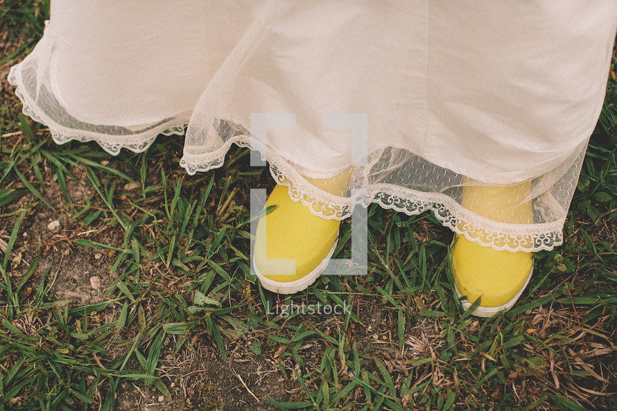 Woman with white dress and yellow rain boots