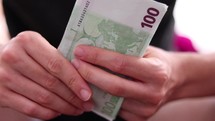 Male hands counting euro bills.